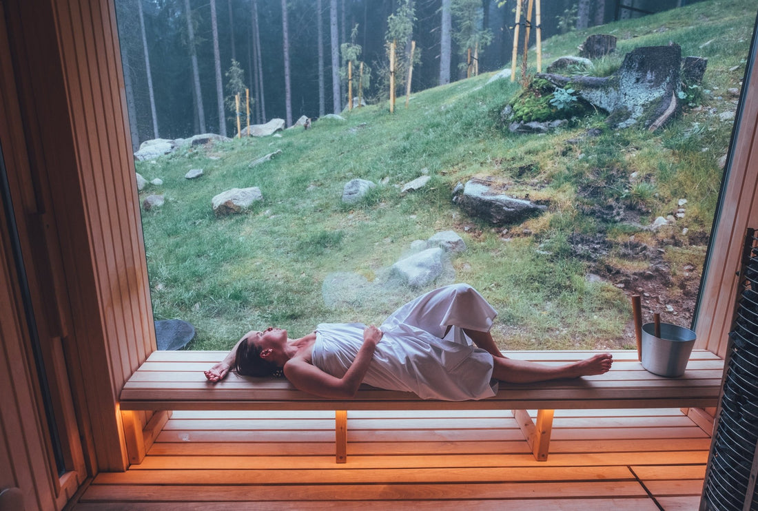 Woman lying on a sauna bench.