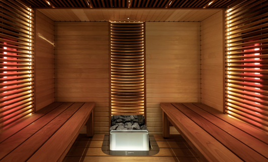 Sauna with wooden benches and heated stones.