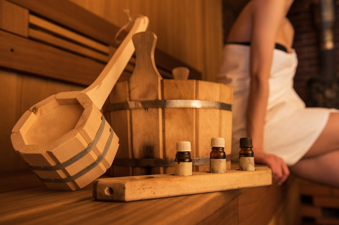 Wooden bucket and essential oils in a sauna.