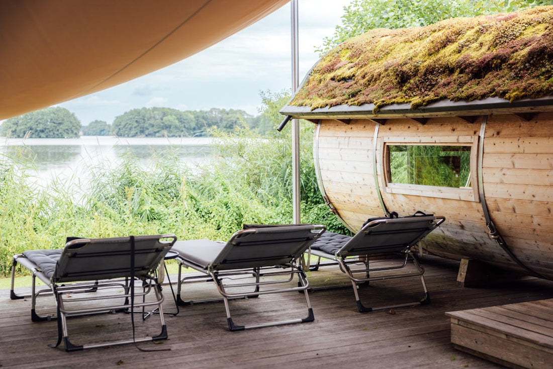 Chairs on a wooden deck next to a sauna.