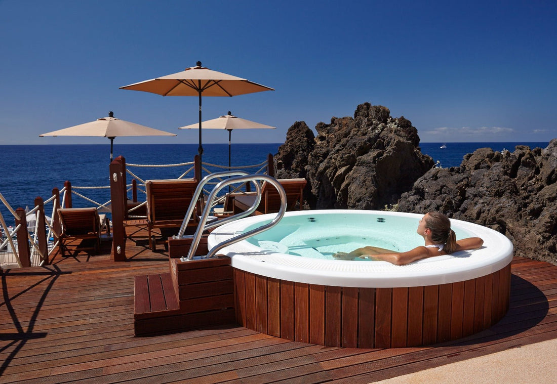 Woman in hot tub overlooking the ocean.