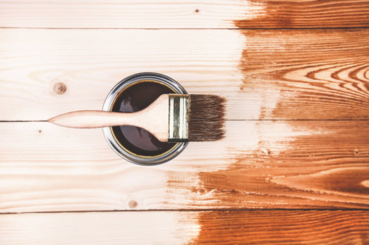 Paintbrush in a brown paint can.