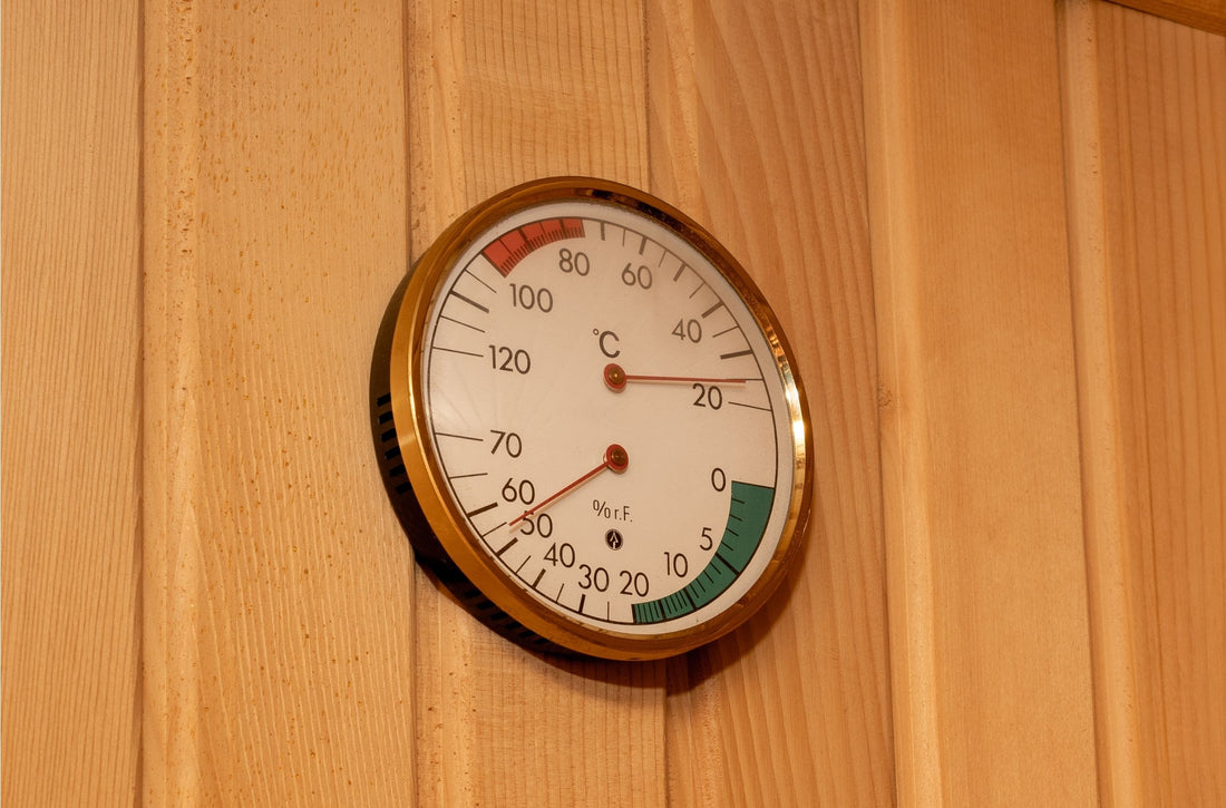 Circular thermometer hanging on a wooden wall.