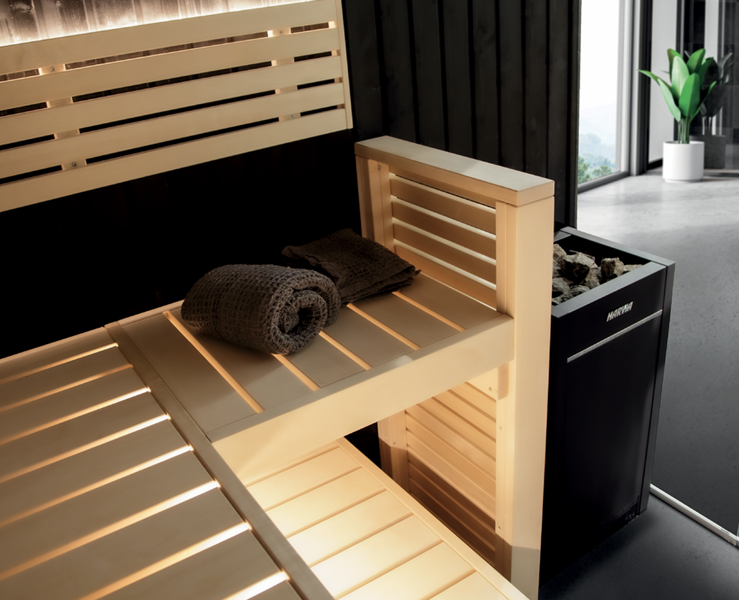 Fenix sauna with wooden bench and towel.