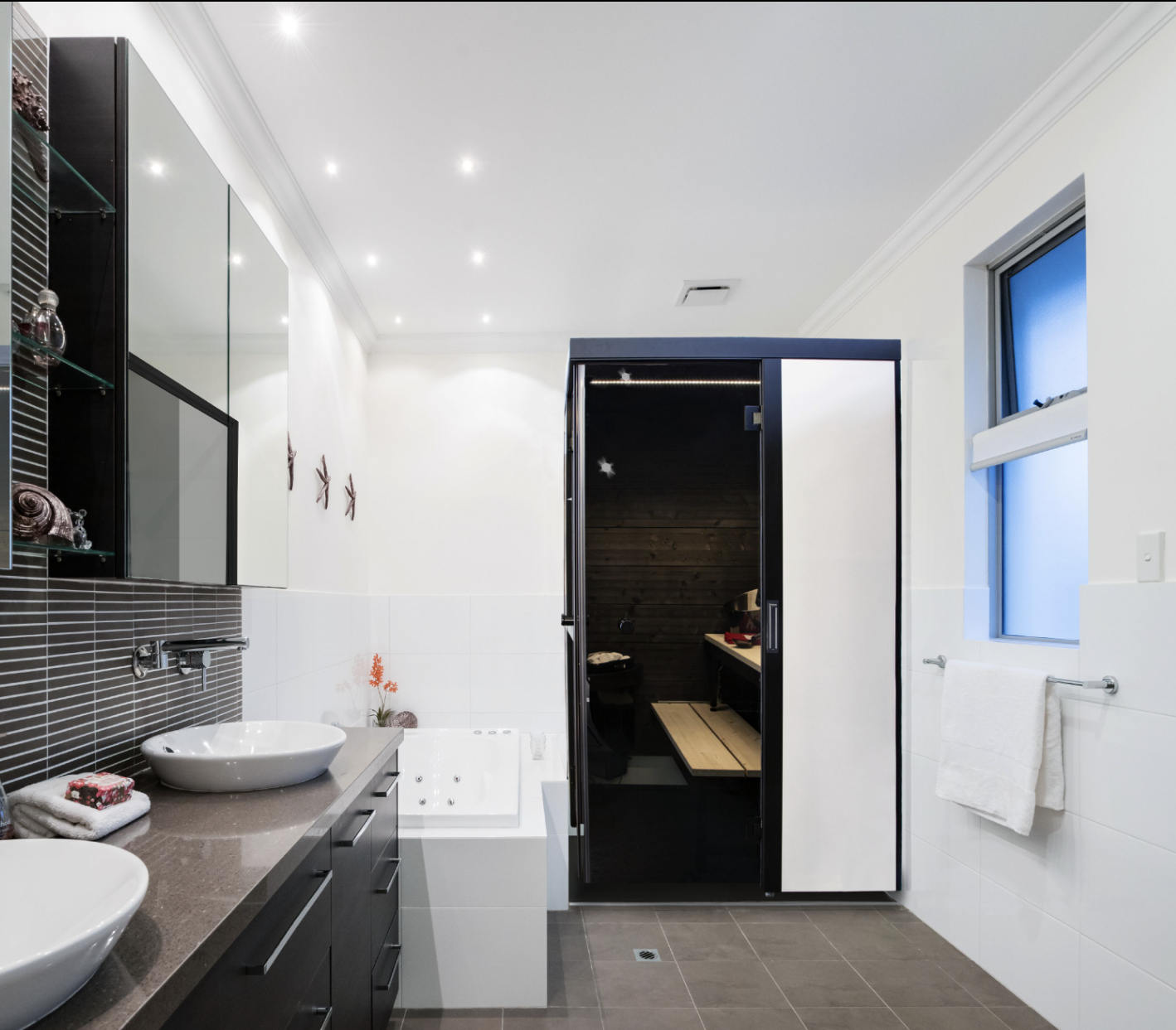 SmartFold sauna in a modern bathroom with sink and bathtub.