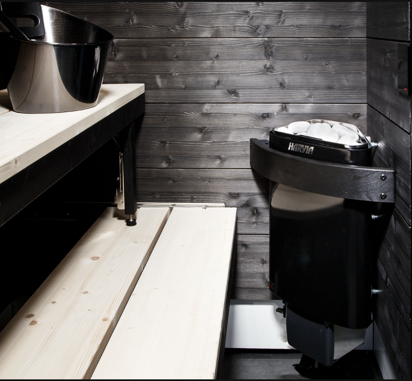 SmartFold sauna next to a wooden bench.