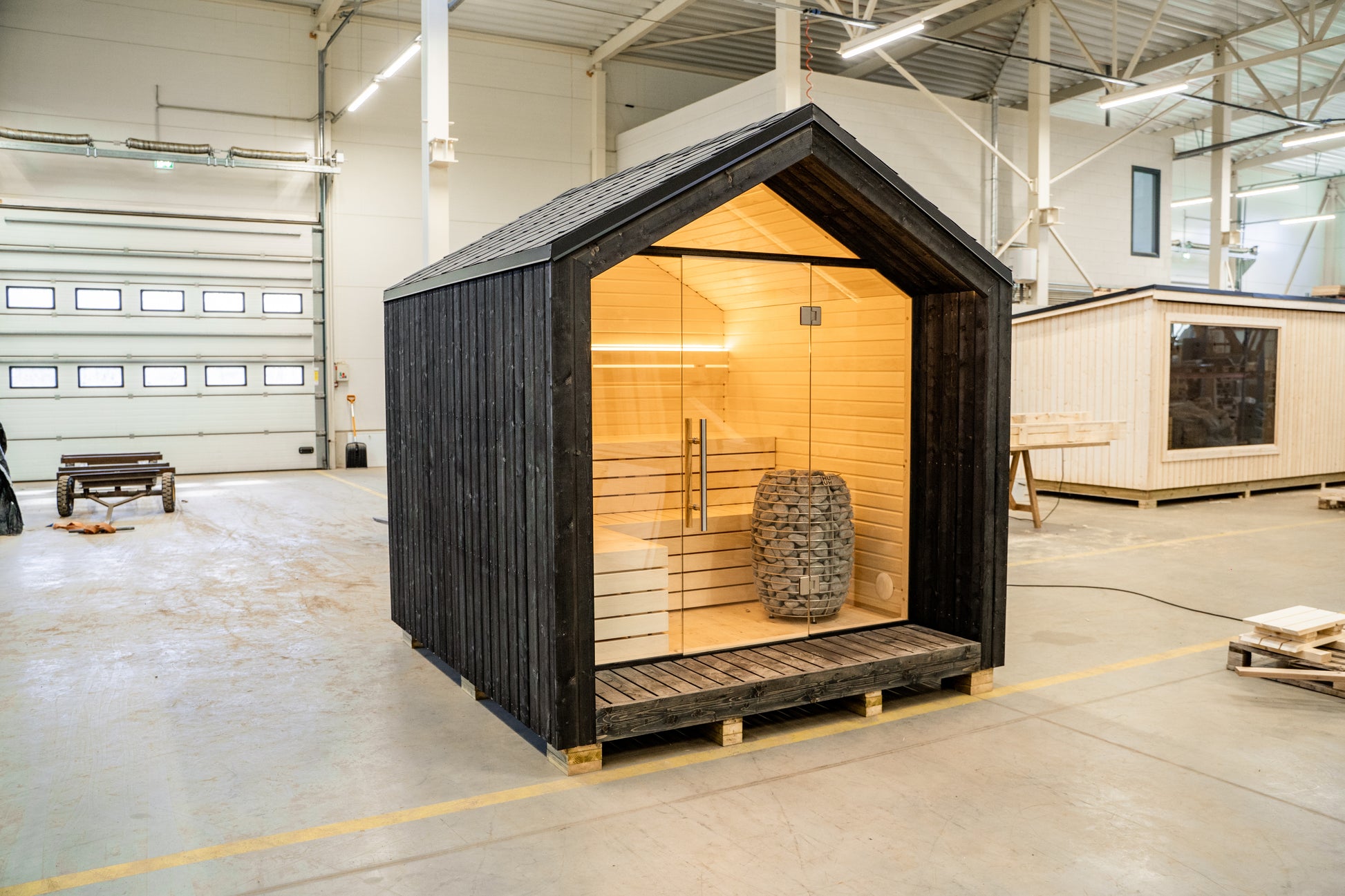 LUMI sauna with glass door and electric heater.