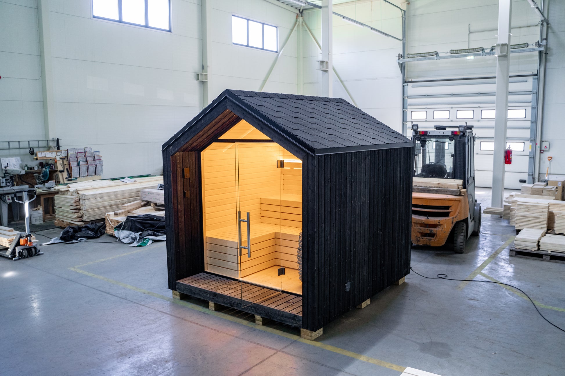 LUMI insulated outdoor sauna with glass wall.