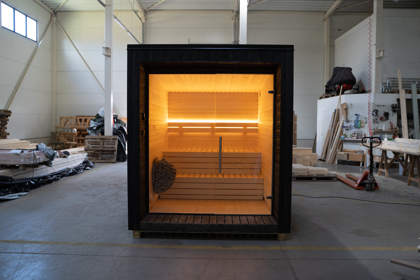 LUMI sauna with glass wall indoors.