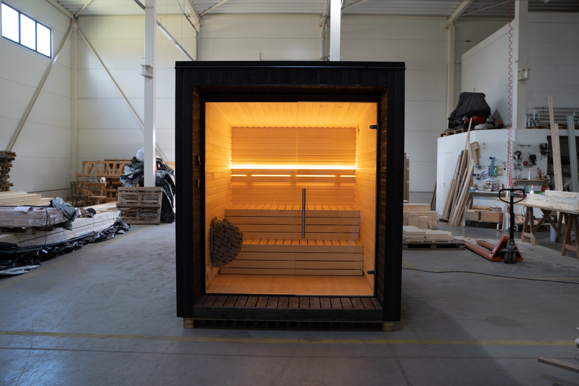 LUMI sauna with glass wall indoors.