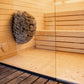 LUMI sauna with stone basket and glass wall.