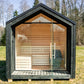 Isolated outdoor sauna Saunamo Lumi in a grassy area.