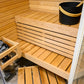 Sirius Corner sauna with wooden benches and black bucket.