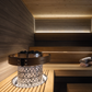 Harvia LED lighting set in sauna with stones and bucket.