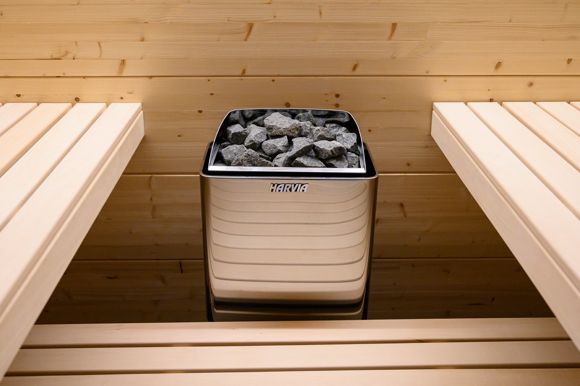 Harvia KIP electric heater with stones in metal bucket.