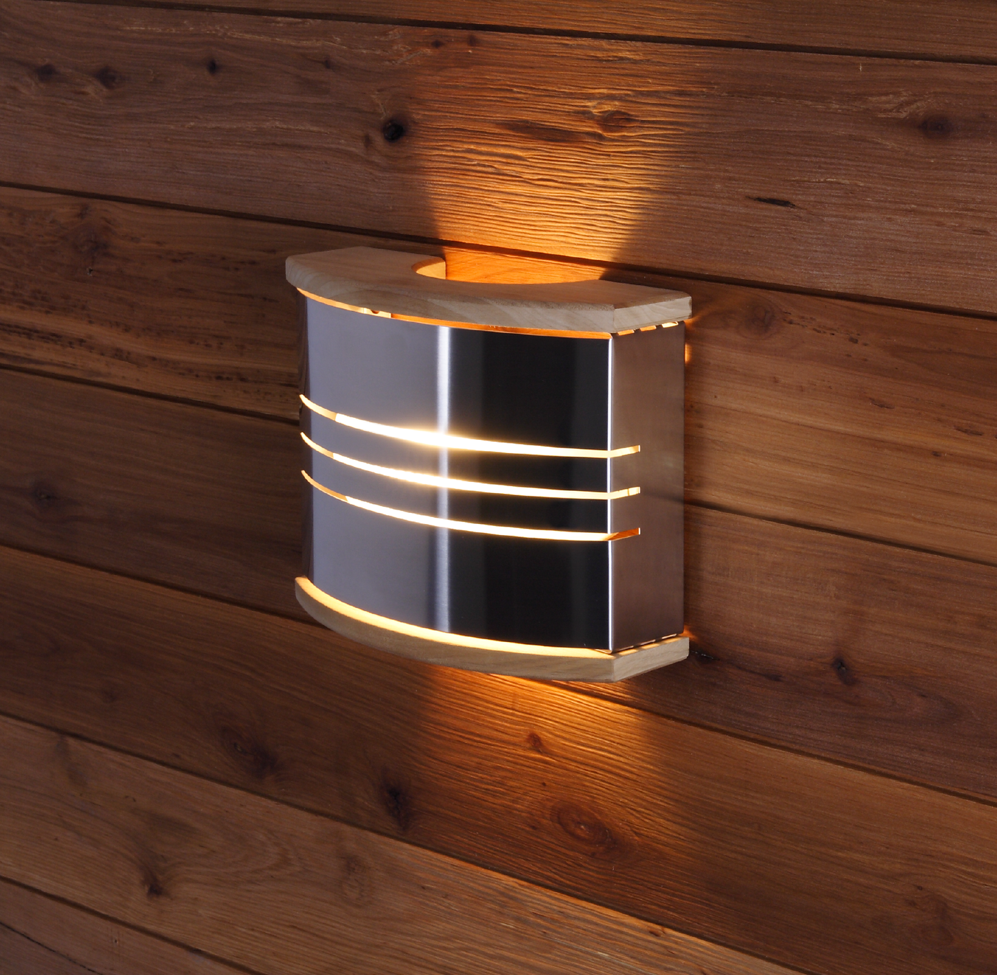 Harvia steel sauna light on wooden wall.