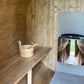 Outdoor sauna 230 in wooden surroundings.