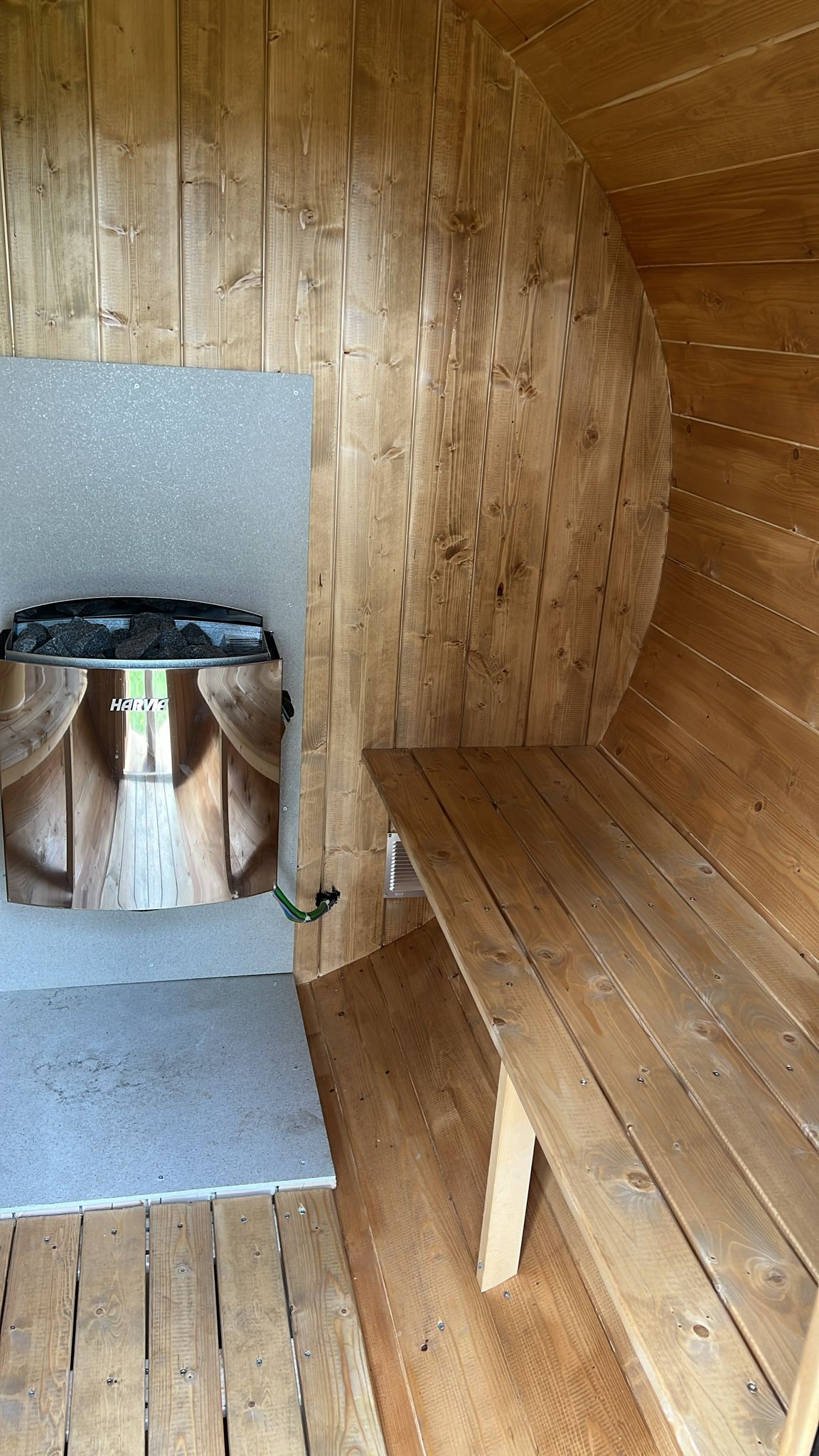 Outdoor sauna 230 with bench and mirror.