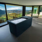 Cold Plunge Steel bathtub with ice and window at the bottom.