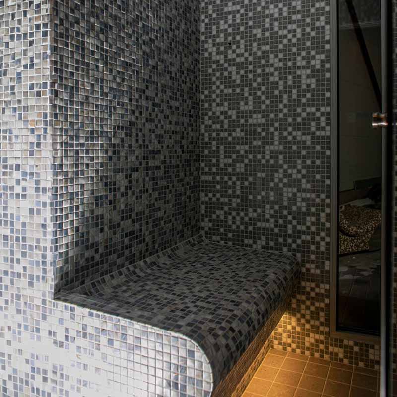 KUUT Outdoor Steam Sauna in a tiled bathroom.