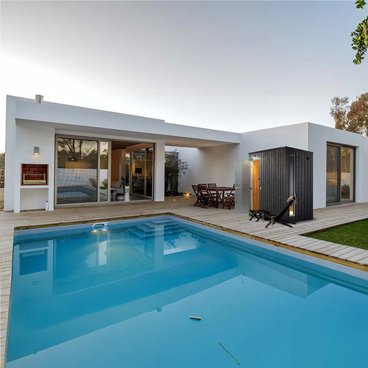 KUUT - Outdoor steam room with wooden deck and swimming pool.