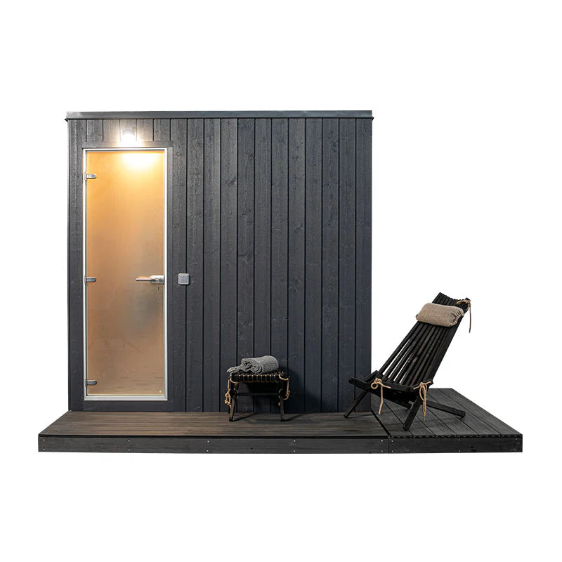 KUUT - Outdoor steam sauna next to a door.