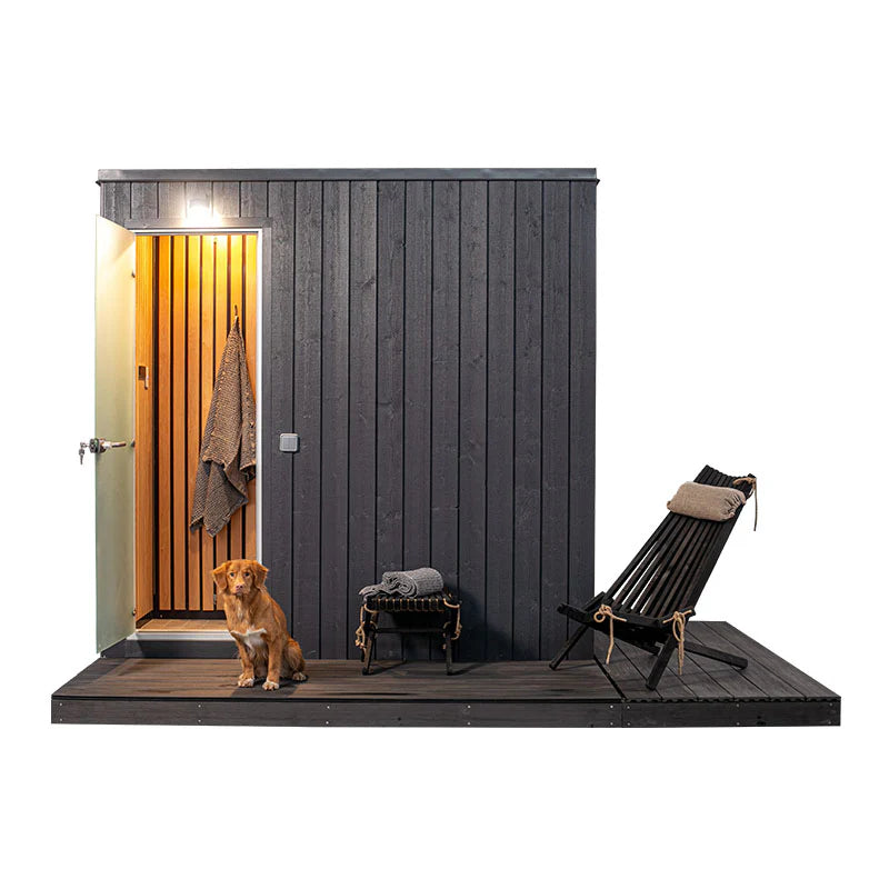 KUUT - Outdoor steam sauna next to a dog and chair.