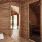 Sauna Saunamo Hobbit 500 with glass door and wooden wall.