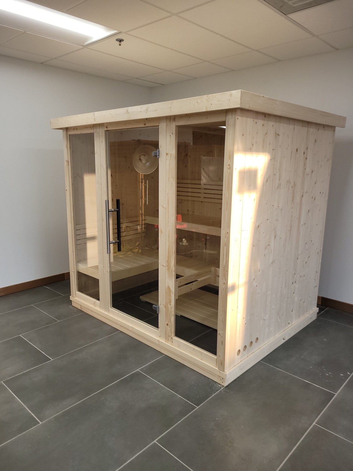 Large indoor sauna with tempered glass doors.