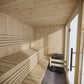 Large wooden indoor sauna with windows and benches.