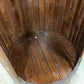 Wooden barrel shower with open structure.