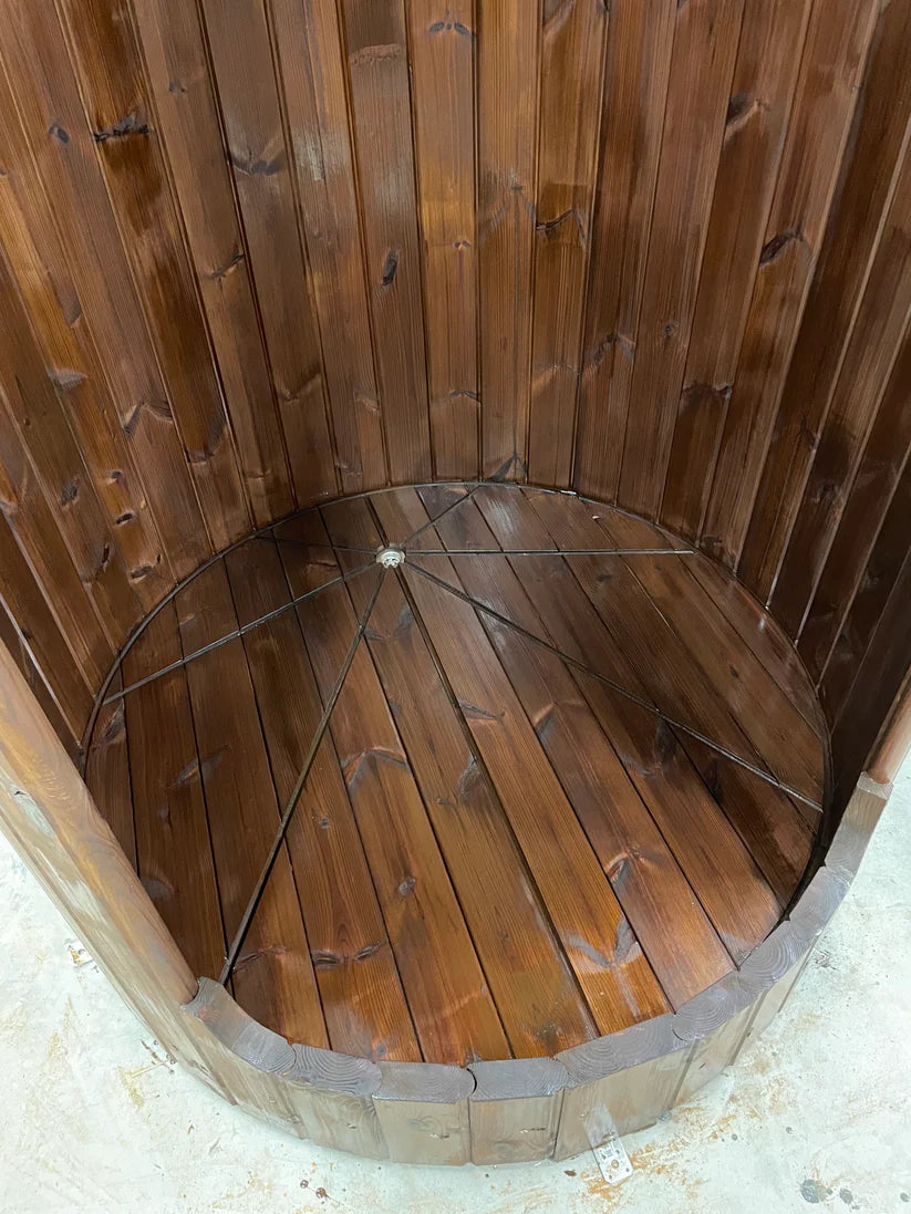 Wooden barrel shower with open structure.